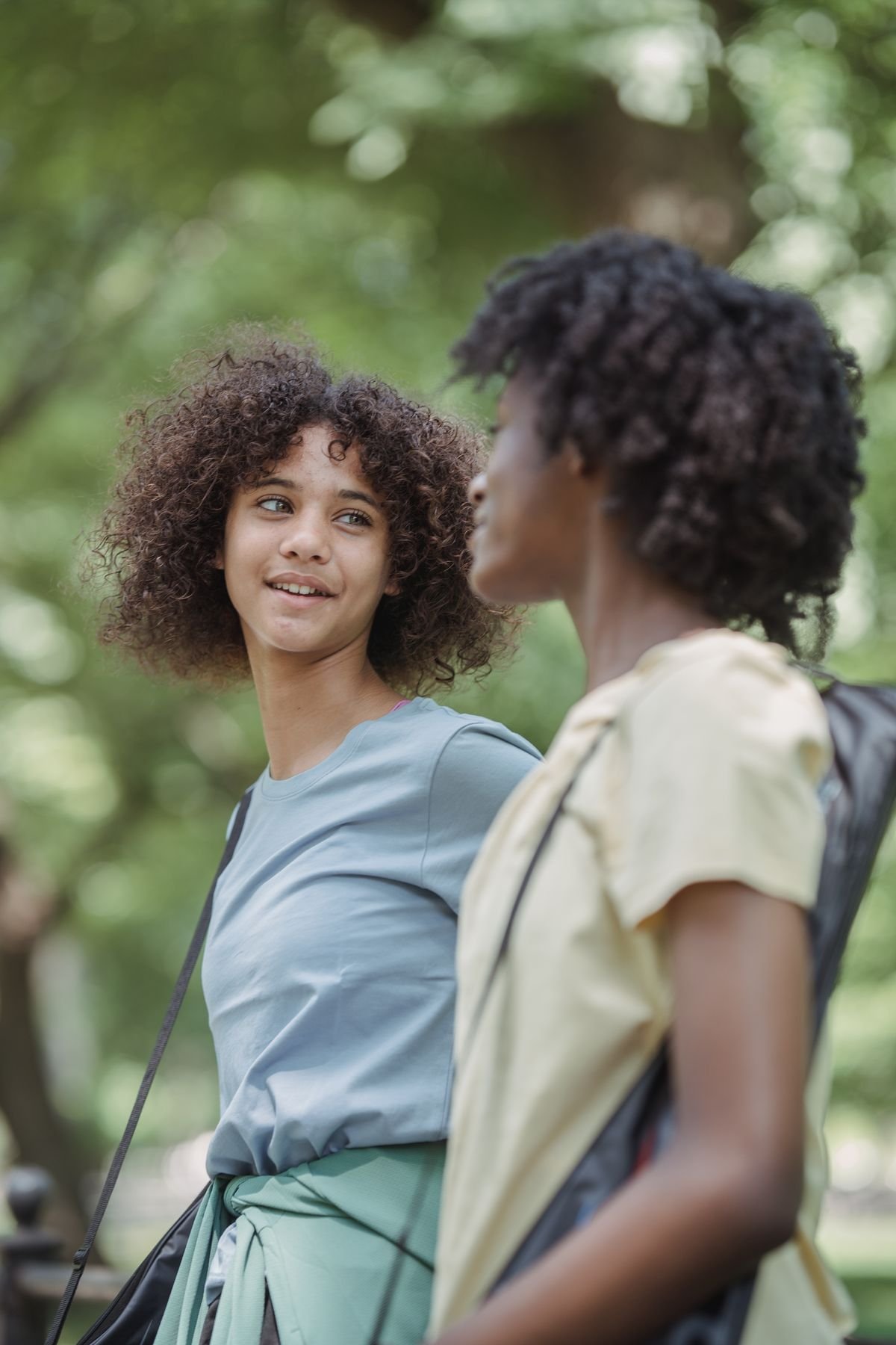Two people talking one-on-one during a walk in the park